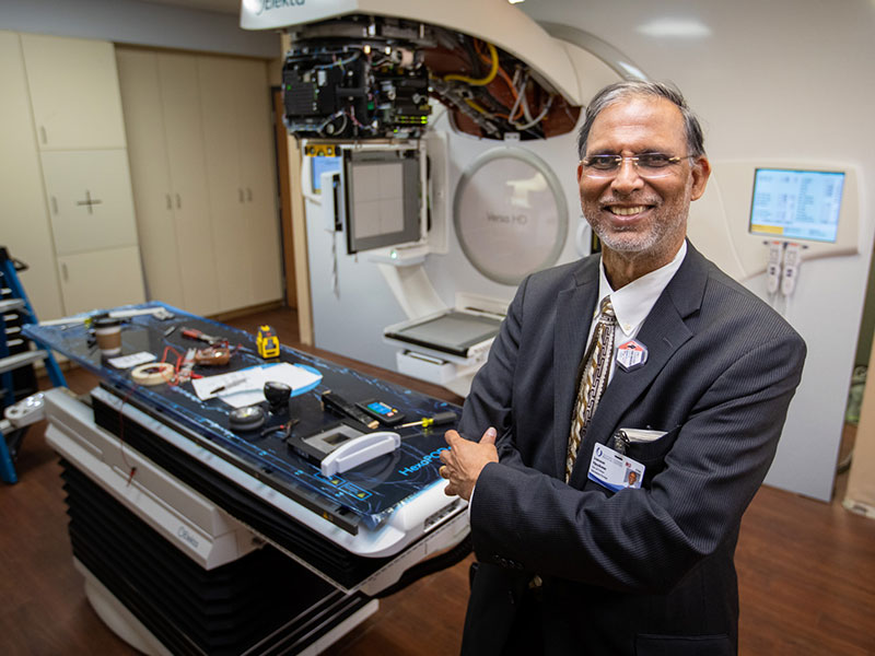 Dr. Srinivasan Vijayakumar, who leads the UMMC Department of Radiation Oncology, as a penchant for working to update processes or equipment that enhance cancer care. He's standing by a new Eleka Versa HD linear accelerator that currently is being installed.