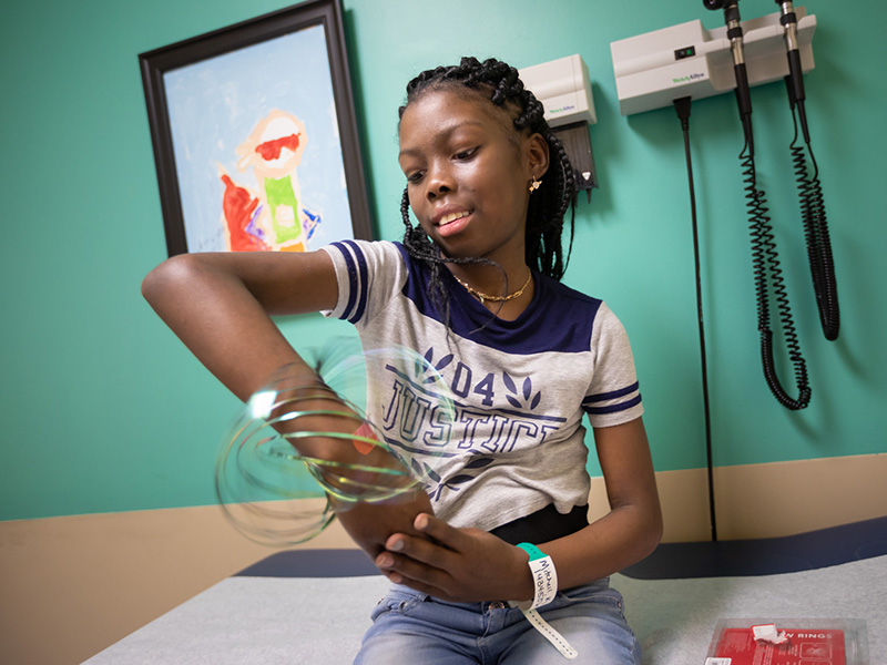 During a visit to Children's of Mississippi in October, Kali Mitchell plays with spinning rings, one of the toys given to patients during check-ups.
