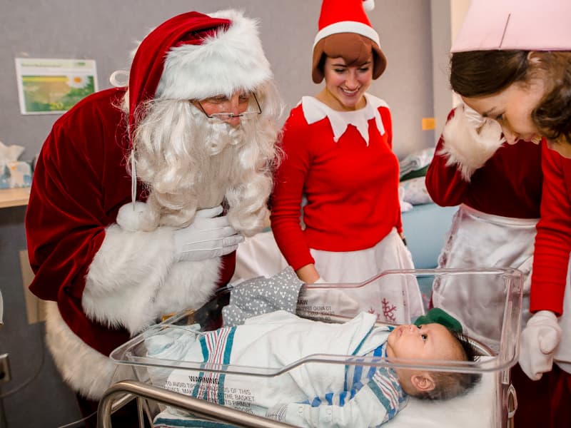 Children's of Mississippi patient Maximillian Ma of Ridgeland gets a personal visit from Santa Claus, Mrs. Claus and their elves.