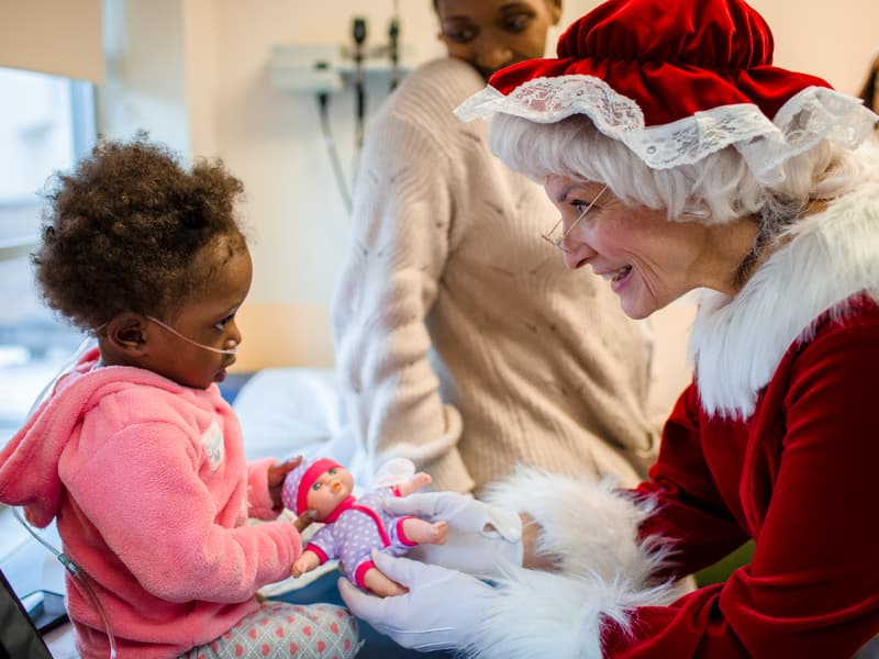 Liberty Edwards of Cleveland gets a doll from Mrs. Claus during a visit to Children's of Mississippi's Eli Manning Clinics for Children.