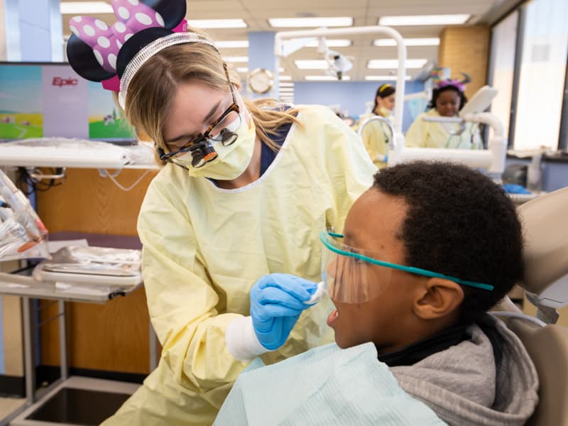 Dental hygiene student with pediatric patient. 