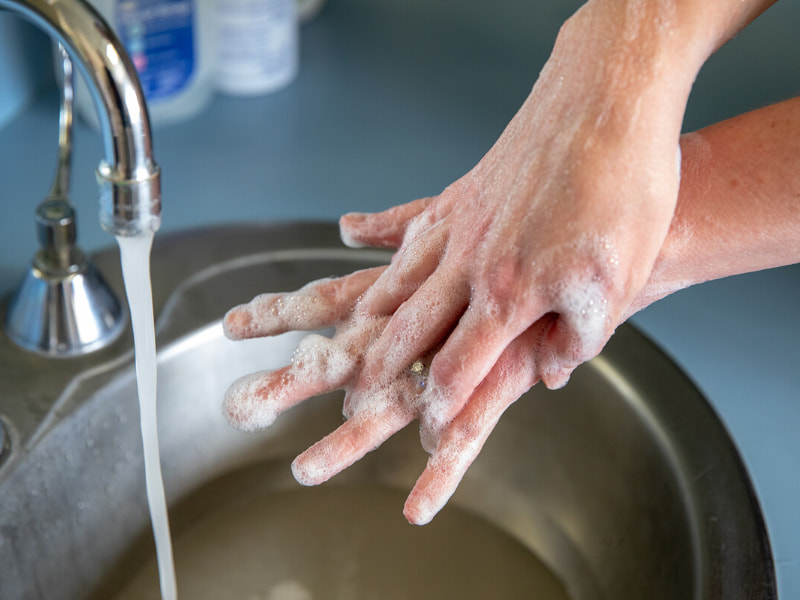 Washing hands in soap in water