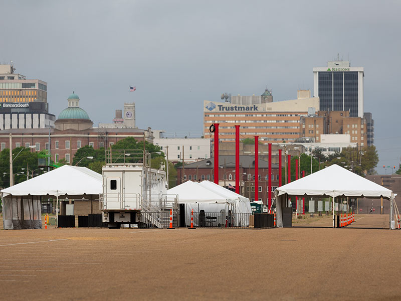 Large white tents set up at fairgrounds.