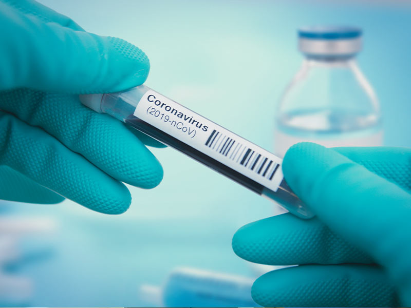 Hands holding coronavirus tube. Stock art from Getty Images.