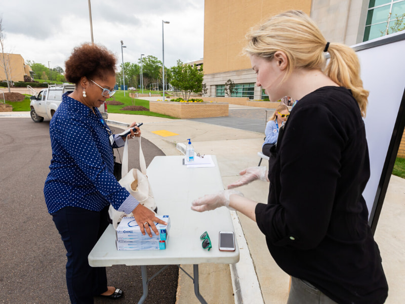 Department of Psychiatry project manager Erin Shirley Orey drops off boxes of gloves as a donation to the Medical Center's COVID-19 response.