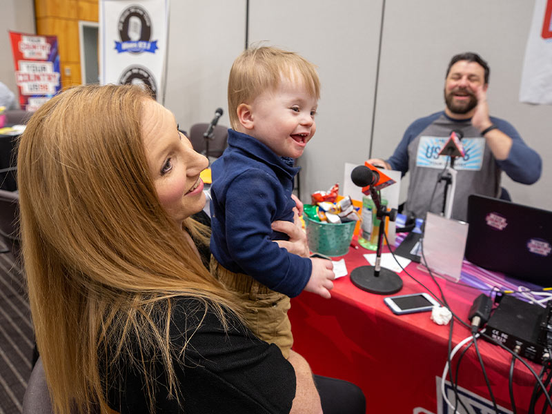 Children's of Mississippi patient Ward Phillips of Madison smiles with mom Abbey during their interview with US 96.3 during the 19th annual Mississippi Miracles Radiothon.