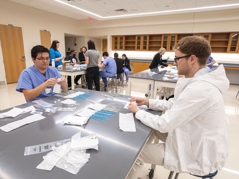 Medical student Martin McCandless, left, and School of Graduate Studies in Health Sciences student Tyler Tunnell volunteer to help make COVID-19 testing kits.