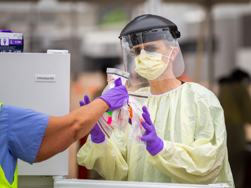 Mark Rankin, a UMMC endoscopy registered nurse, prepares specimens for COVID-19 testing.