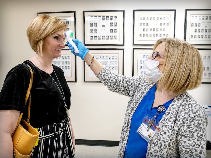 UMMC Dental Employee taking temperature.