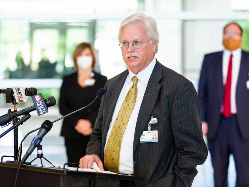 Dr. Richard Summers speaking at a podium.