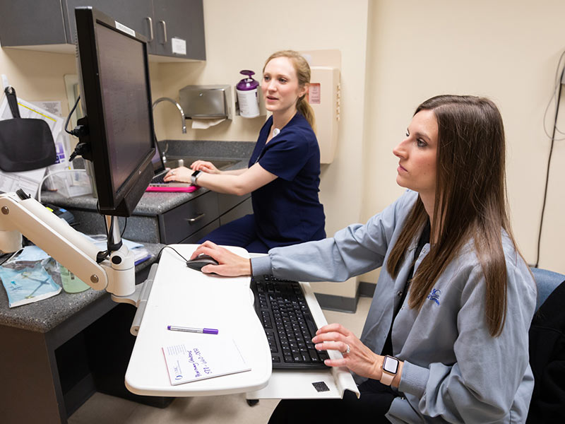 Dr. Caroline Crabtree, left, a UMMC resident, and Bridget Dunlap, a UMMC nurse, conduct patient telehealth appointments before CDC recommendations for face mask usage,