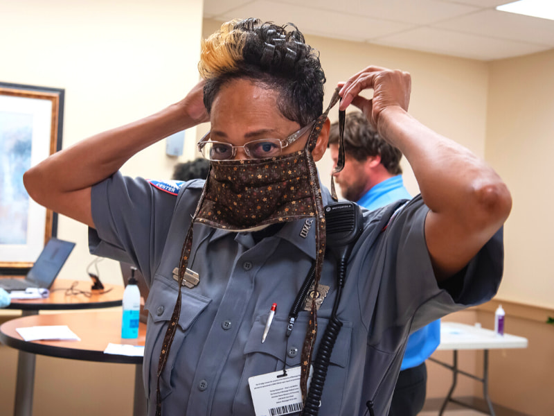 Eureka Robinson with campus police ties her new star-print mask.