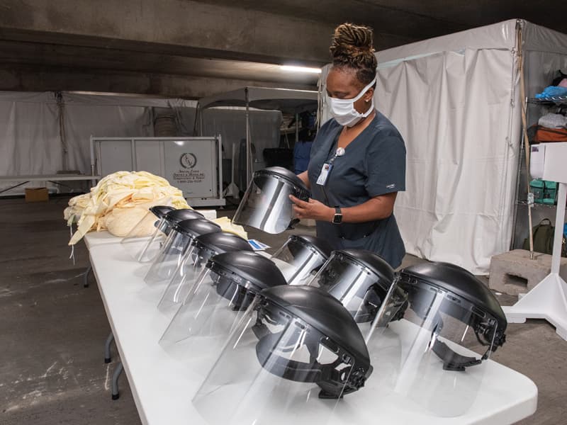 Jacqueline Cavett prepares face shields.