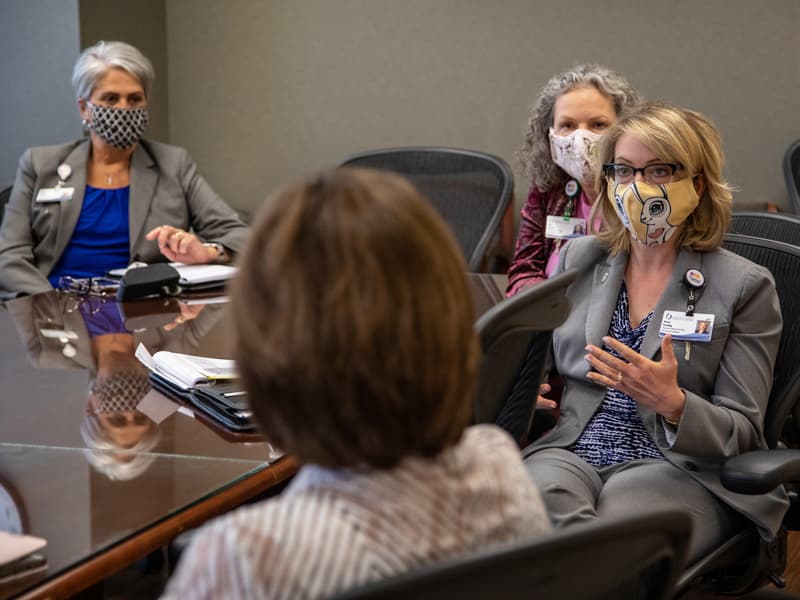 Karen Dowling, right, chief ambulatory and network operations officer for Children's of Mississippi, makes a point in the UMMC Health System weekly leadership meeting to discuss COVID-19 response.