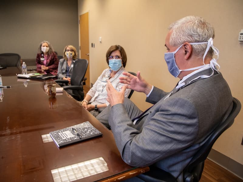 Britt Crewse, right, adult hospitals CEO, discusses COVID-19 response plans with leadership team members, from left, Ellen Hansen, Dowling and Terri Gillespie.