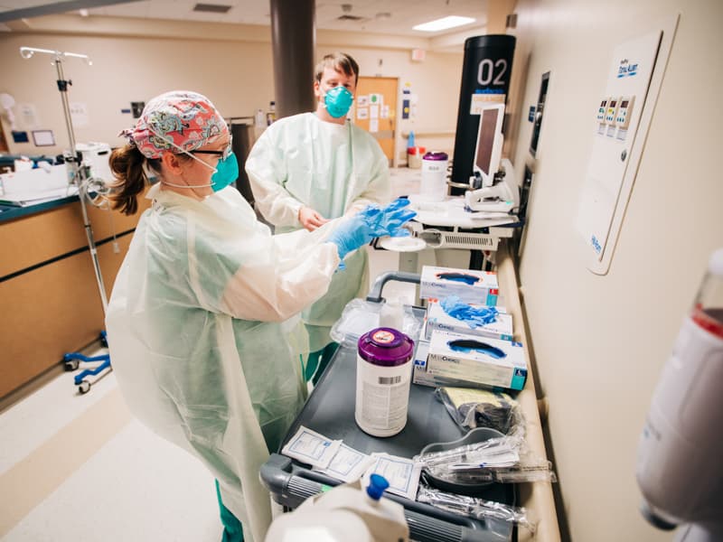 UMMC is preparing to begin COVID-19 antibody testing in employees with high risk of exposure. This includes health care providers like Heidi Logan, nurse on 2 North, and Jacob Ellett, inpatient nurse on 7 South, shown here donning personal protective equipment before entering a COVID-19 patient's room.