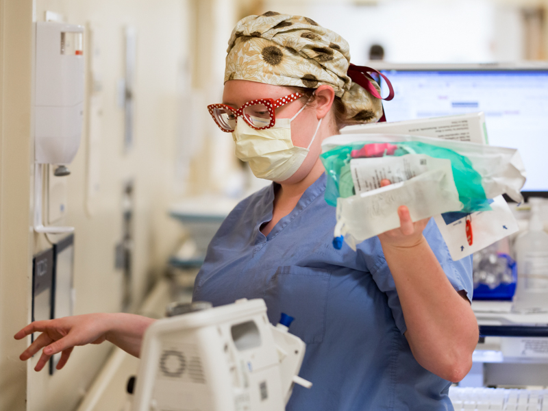 Margaret Workman, a registered nurse on 2 North, prepares supplies that she will later take to the room of one of her COVID-19 patients after donning full personal protective equipment.
