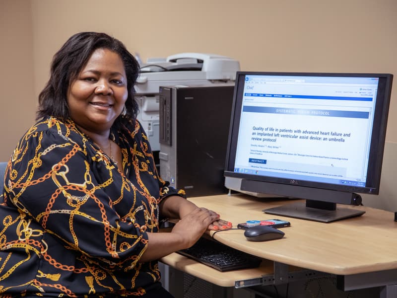 Dorothy Aultman-Abrams, a student in the Doctor of Nursing Practice Program, uses the Cochrane database in her office.