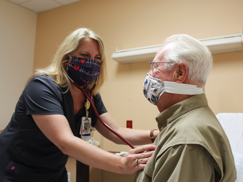 Oktibbeha County Hospital registered nurse Amy White listens to the heart of OCH patient John Orton.