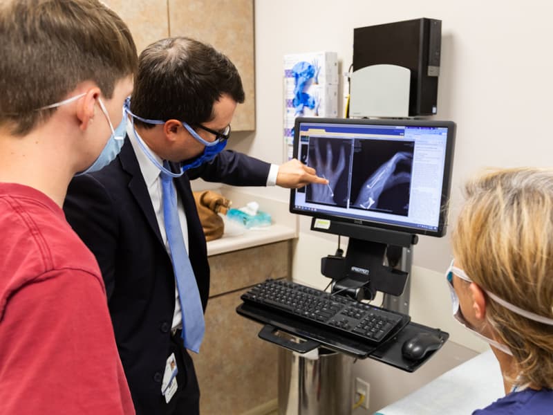 Hunter Lindsay takes a look at his X-rays with Dr. Marc Walker and Dr. Kellie Leitch.