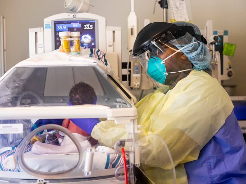 LaShayla Yates, a nurse in the Neonatal Intensive Care Unit, takes care of a baby born to a COVID-positive mother.