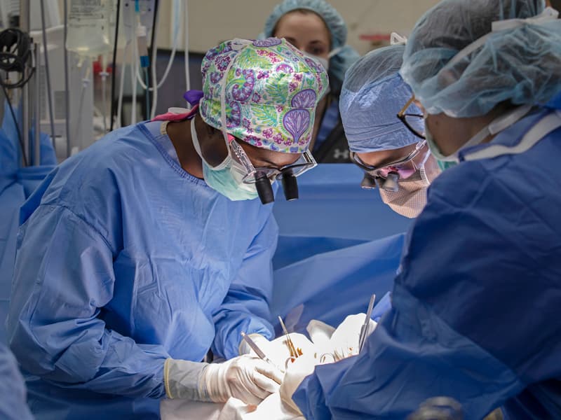 Matemavi, left, performs a recent surgery at UMMC while Dr. Jad Chamieh, center, a general surgery resident, and Savannah Walker, a fourth-year medical student, observe.