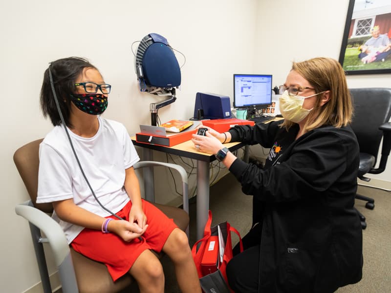 Jocelyn DeZutter, 11, visits with Dr. Beth King, an audiologist in the Department of Otolaryngology – Head and Neck Surgery.