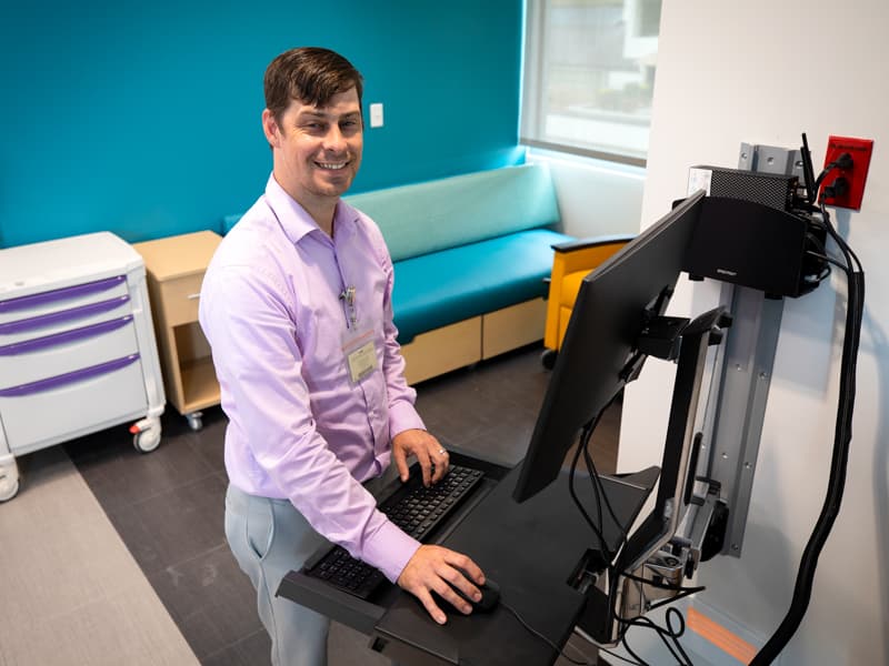 Josh Warren, an information technology specialist in the Division of Information Systems, sets up a computer for use this fall in the new Kathy and Joe Sanderson Tower at Children’s of Mississippi.