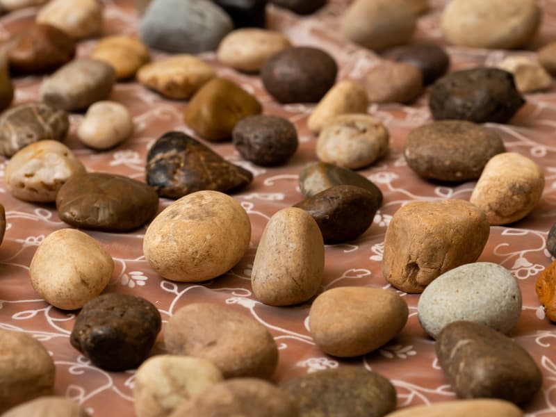 Large group of small stones on an altar table.