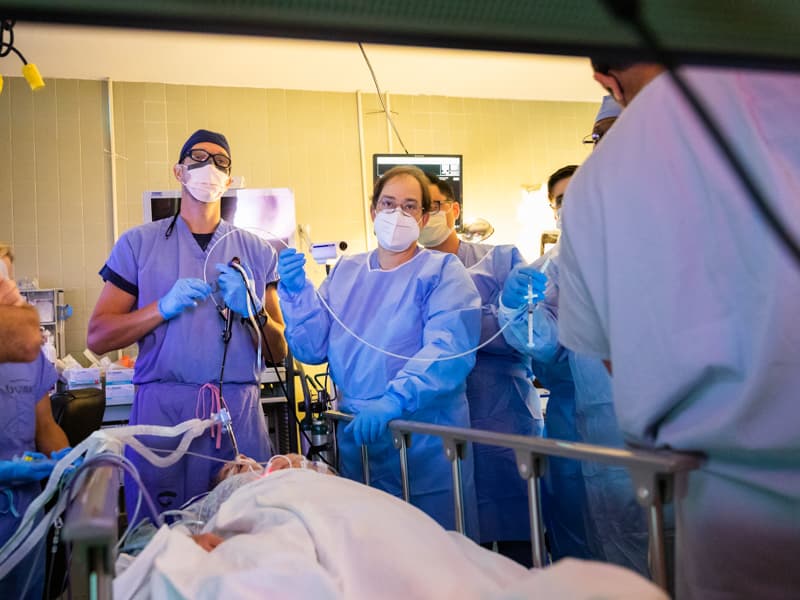 Dr. Michal Senitko, left, and look at a video screen to see images of Tina Price's lungs captured by a small camera on the end of a bronchoscope.