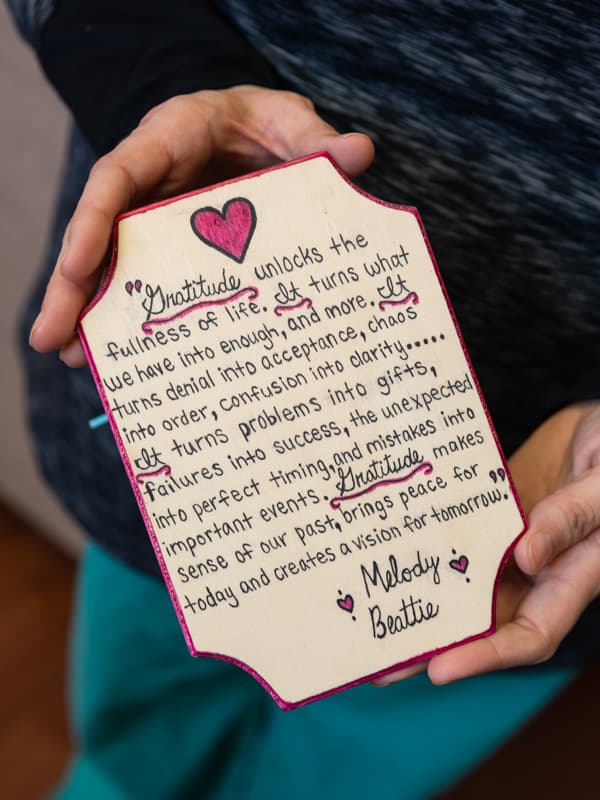 Patterson keeps this plaque, an expression of gratitude from a grieving patient, on her desk.