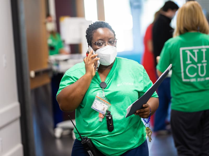 Chief of Newborn Medicine Dr. Mobolaji Famuyide communicates with her team during the transfer of patients to the NICU floors of the Sanderson Tower.