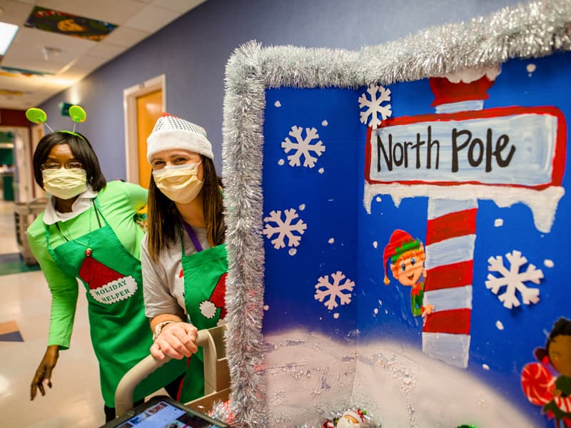 Child life assistant Michelle Chambers and specialist Pepper Weed-Cooper greeted Children's of Mississippi hospital patients with the "Santa Claus is Coming to Town" float in the "Rockin' Around Children's" parade.