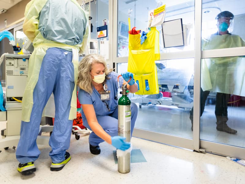 Kelly Jones, a supervisor and registered respiratory therapist, prepares oxygen for a COVID-19 patient in the medical intensive care unit.