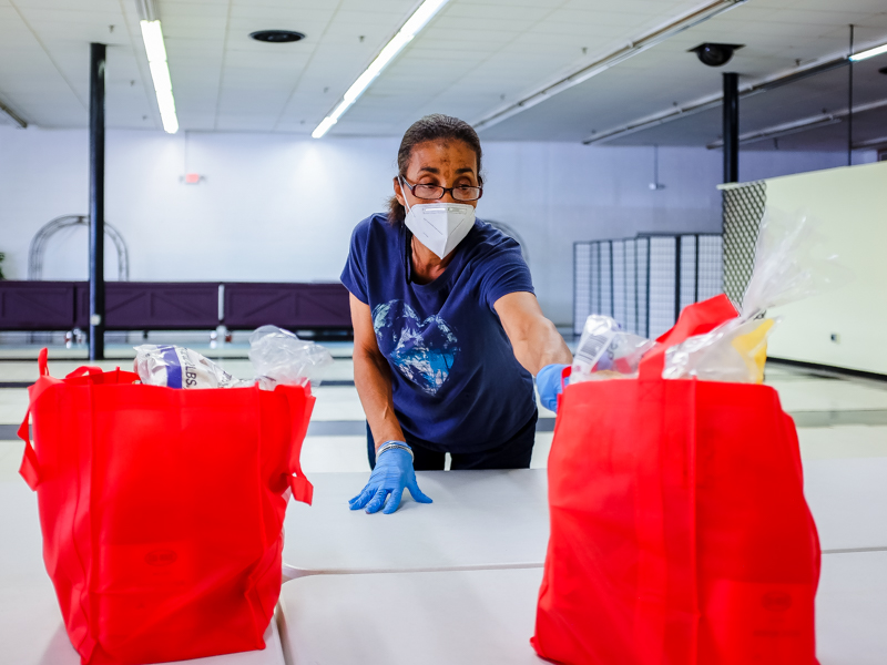 Willamenia Turner, a volunteer at the EversCare food pantry, helps safely bag up food for recipients.