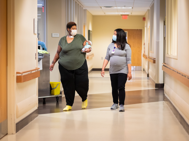 Cessie Stringer carries a weighted baby doll during physical therapy with Veronica Taylor at Methodist Rehabilitation Center.