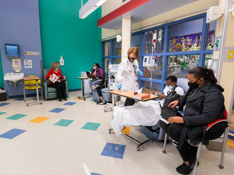 Jordan Carroll of Liberty, a Children's of Mississippi patient, and his mother, Retasia, read during his treatment in the Center for Cancer and Blood Disorders infusion room.