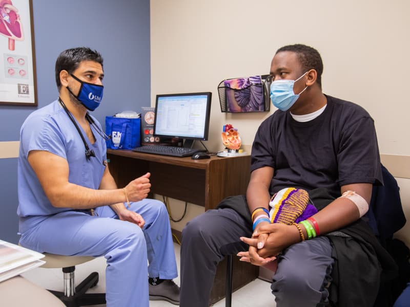 Dr. Gabriel Hernandez, an assistant professor of medicine in the Division of Cardiovascular Diseases, queries R. J. Stewart on his progress.