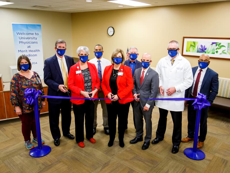 Taking part in the ribbon-cutting for University Physicians' new clinic space at Merit Health Madison were, from left, medical office assistant Karla Dukes; Dr. Martin Tucker, chairman of the Department of Obstetrics and Gynecology; Margaret Head, chief ambulatory officer for UMMC adult hospitals; Dr. Jared Davis, assistant professor of plastic surgery; Dr. LouAnn Woodward, vice chancellor for health affairs and dean of the School of Medicine; Paul Bird, director of surgical ambulatory operations; Dr. Alan Jones, associate vice chancellor for clinical affairs; Dr. Christopher Anderson, James D. Hardy professor and chair of the Department of Surgery; and Dr. Channing Twyner, assistant professor of anesthesiology.