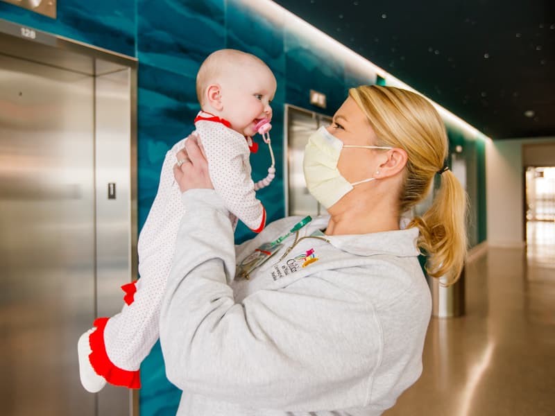Registered nurse Lesley Otts visits her Children's Heart Center patient Vivi Hebert.