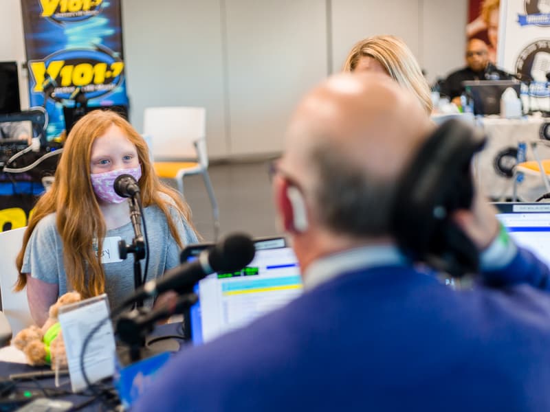 Mix 98.7 program director John Anthony interviews Avery Bell, a Children's Heart Center patient at Children's of Mississippi.