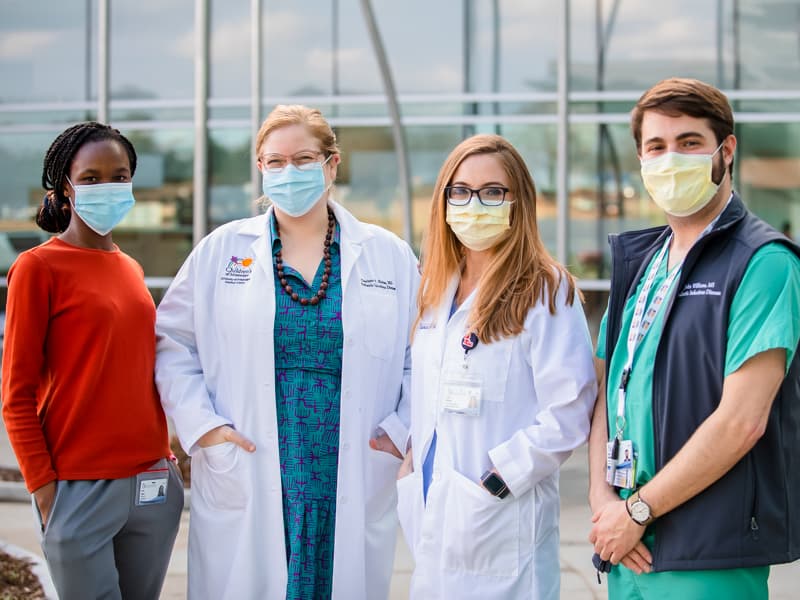 Department of Pediatrics employees studying COVID-19 include, from left, Urita Agana, researcher; Hobbs; Lora Martin, nurse practitioner; and John Williams, researcher.