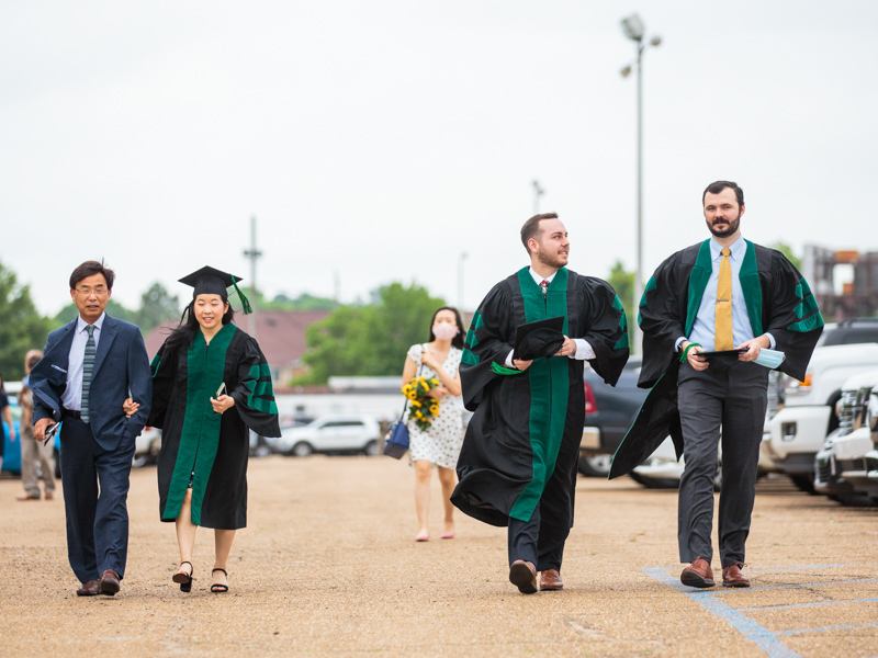 Doctor of Medicine candidate Praise Seo, left with her father Simon Seo, and fellow M4s Reid Black and Trey Redd.