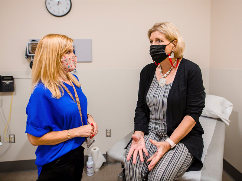 Dr. Alaina Herrington, left, director of the Skills Center at the School of Medicine, listens to Liz Anderson, gynecological teaching associate.