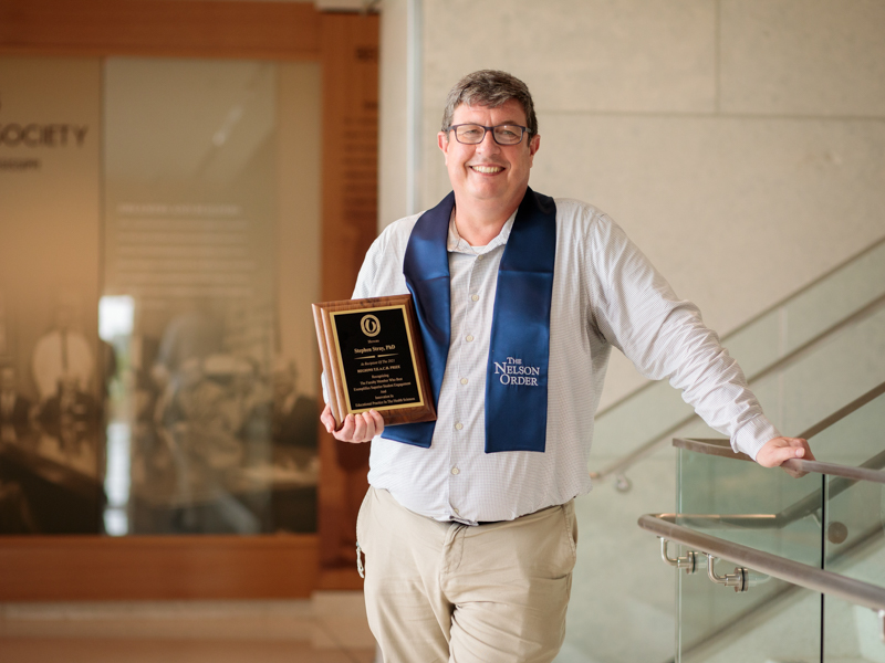 Dr. Stephen Stray, associate professor of microbiology and immunology, displays his 2021 Regions Bank TEACH Prize.