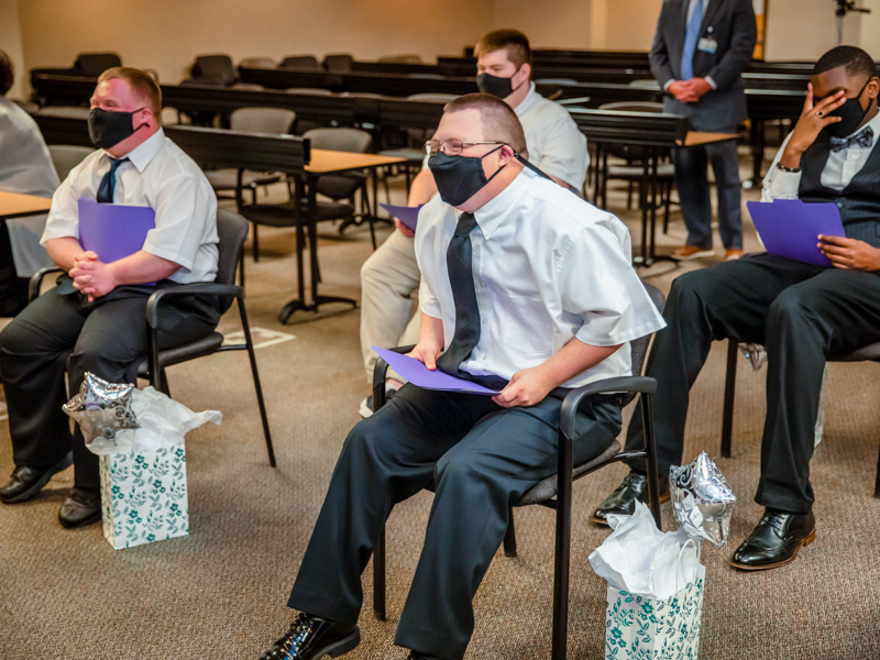 Graduates laugh while watching a slideshow during the Project SEARCH graduation ceremony