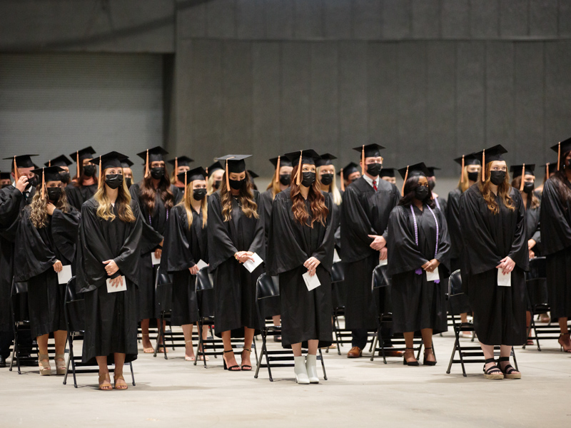 Bachelor of Science in Nursing degree candidates rise during commencement for the School of Nursing.