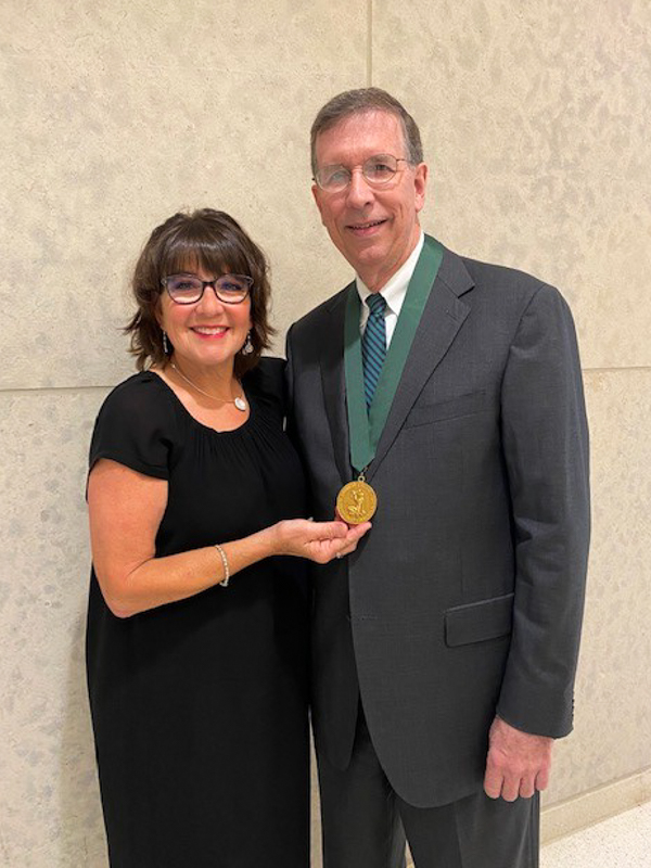 Dr. J. Martin Tucker was presented the presidential medal of the American College of Obstetrics and Gynecology by his wife, Robin.
