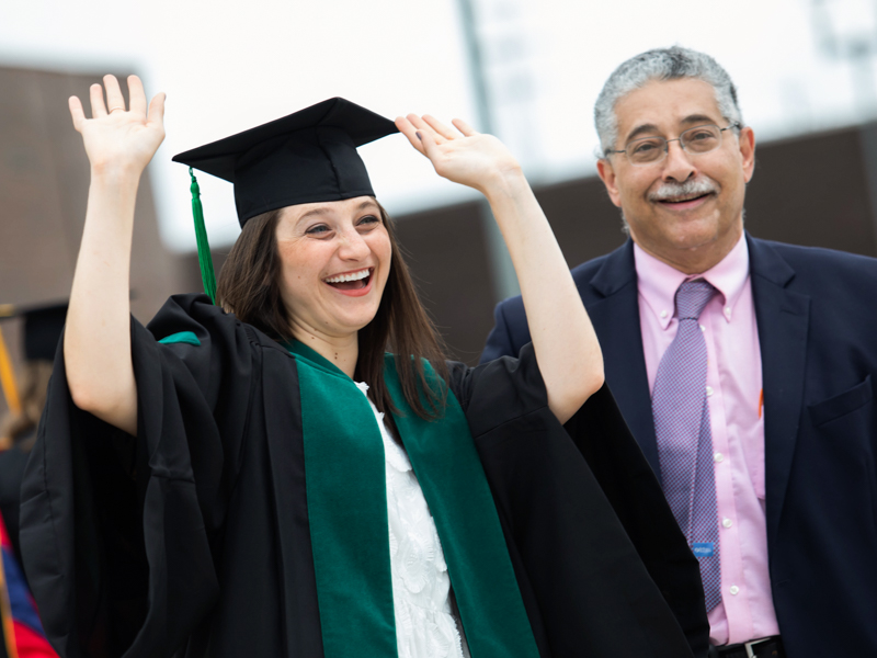 School of Medicine student Mariam Ebeid shouts "whoop, whoop" to fellow graduates while her father, UMMC physician Dr. Makram Ebeid looks on prior to commencement ceremonies May 28 at the Mississippi Coliseum.
