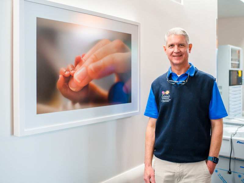Dr. Mark Reed, chief of pediatric otolaryngology, shows one of his photos that now graces the NICU walls in the Sanderson Tower.